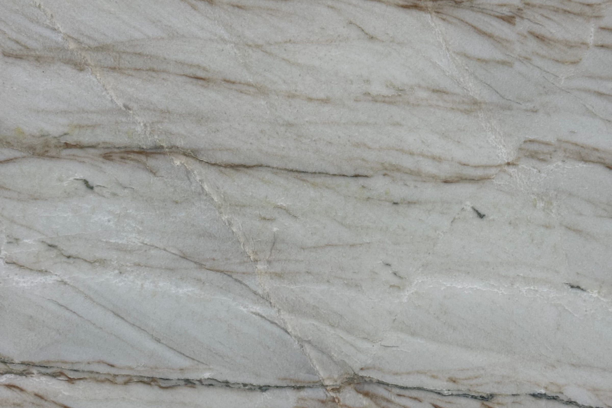 Pale gray stone with thin parallel brown lines running diagonally across the slab