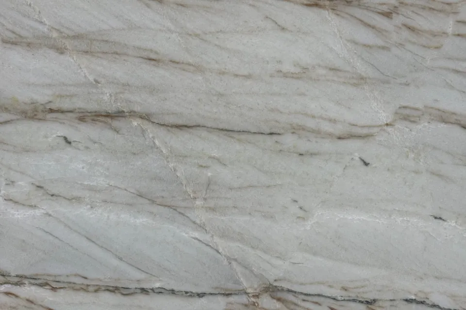Pale gray stone with thin parallel brown lines running diagonally across the slab