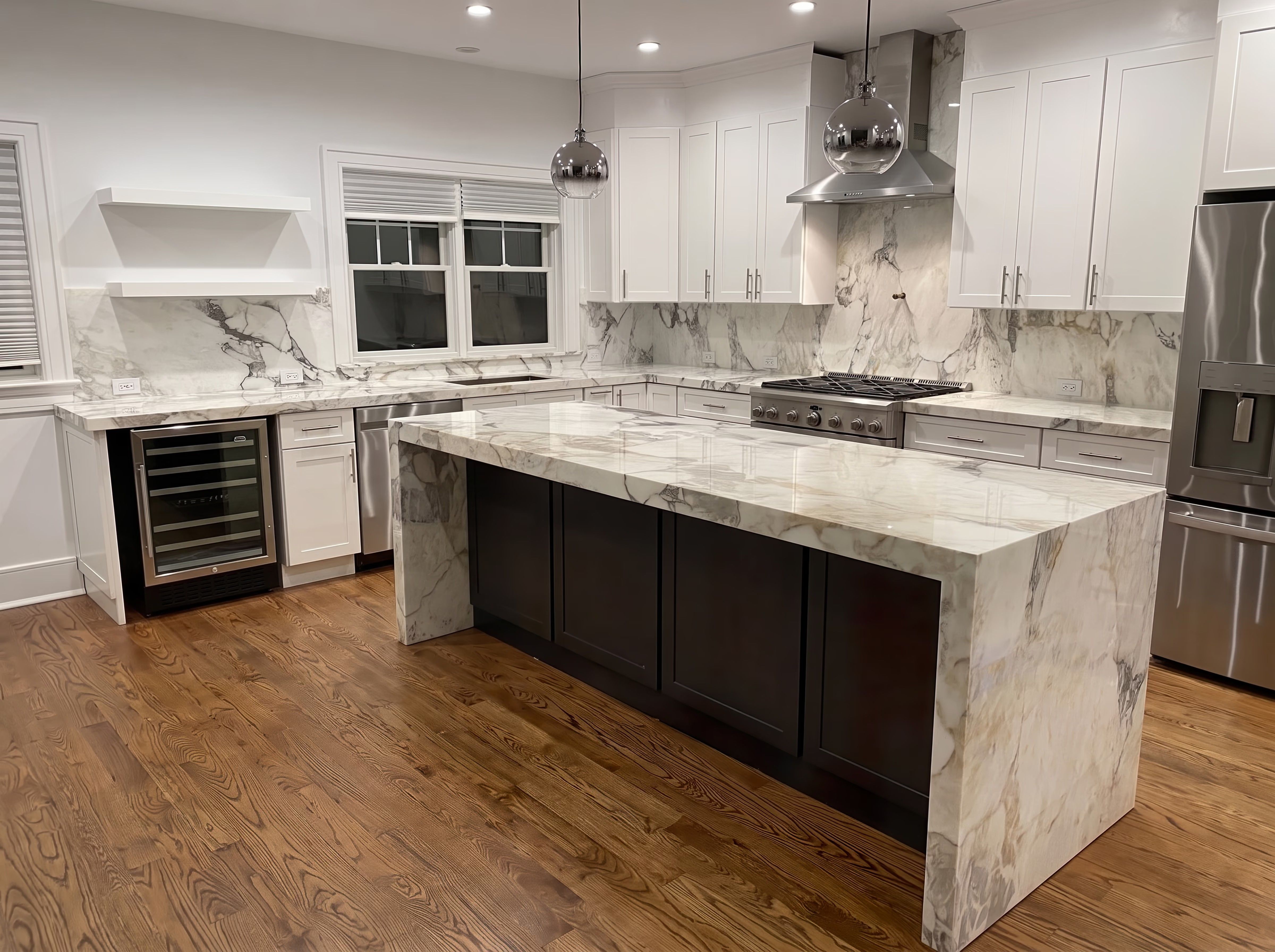White marble kitchen island with mitered waterfall ends, polished