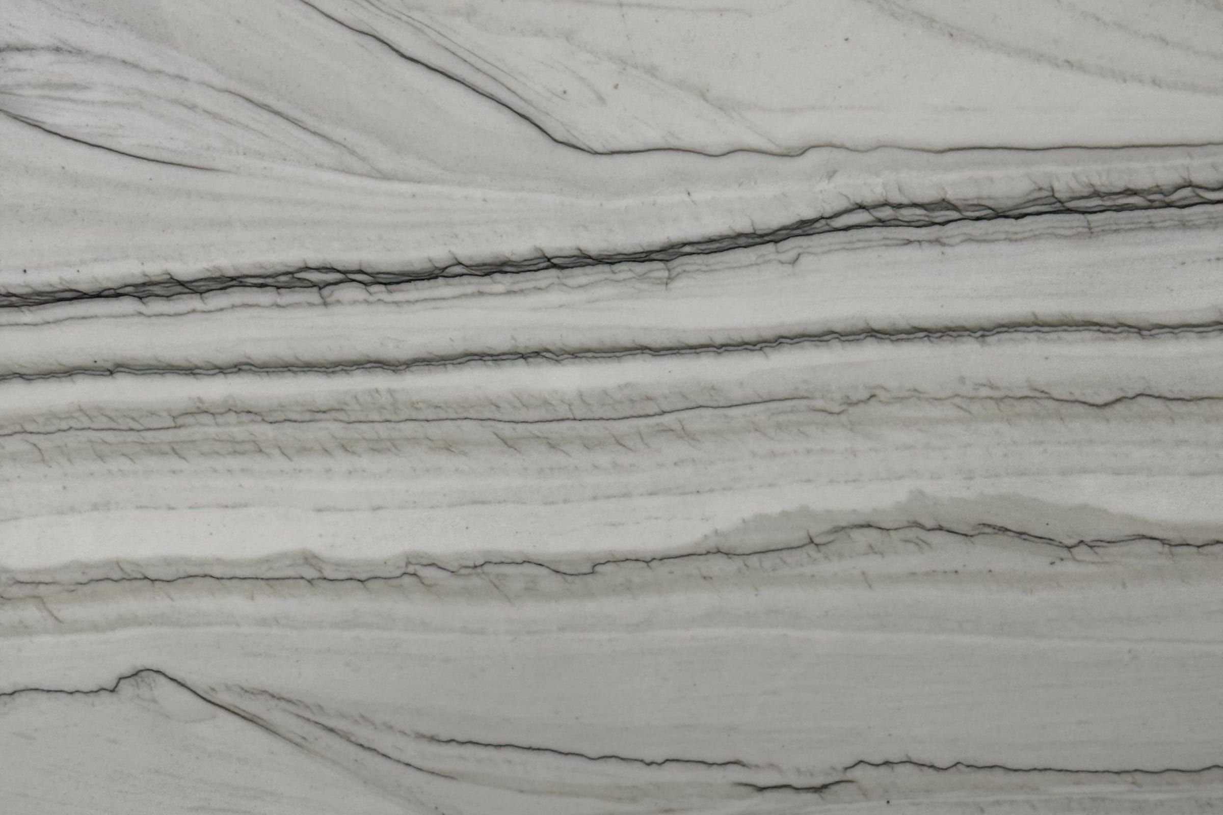 Pale gray stone with thin dark horizontal lines and layered bands, matte surface
